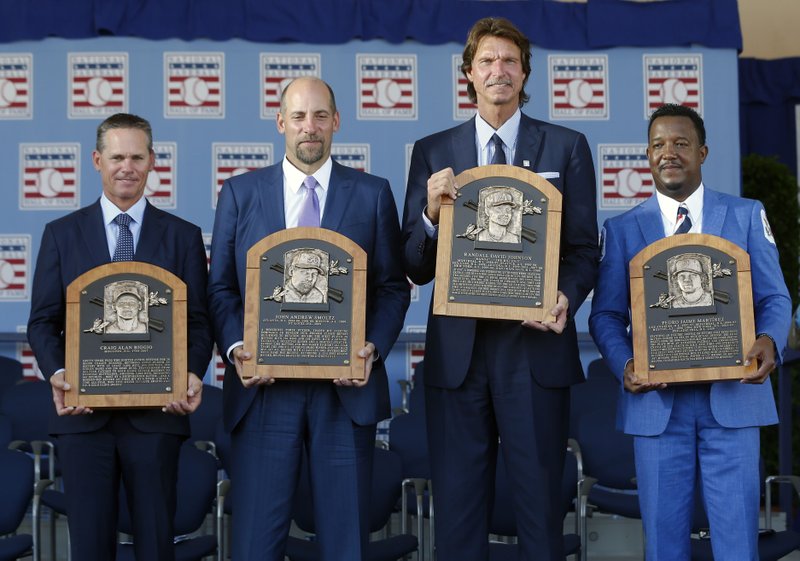 Newly-inducted National Baseball Hall of Famers from left to right, Craig Biggio, John Smoltz, Randy Johnson and Pedro Martinez hold their plaques after an induction ceremony at the Clark Sports Center on Sunday, July 26, 2015, in Cooperstown, N.Y. (AP Photo/Mike Groll)