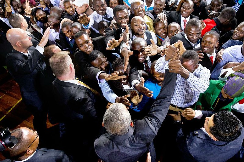 President Barack Obama (bottom) greets Kenyans after delivering a speech at the Safaricom Indoor Arena in Nairobi on Sunday.