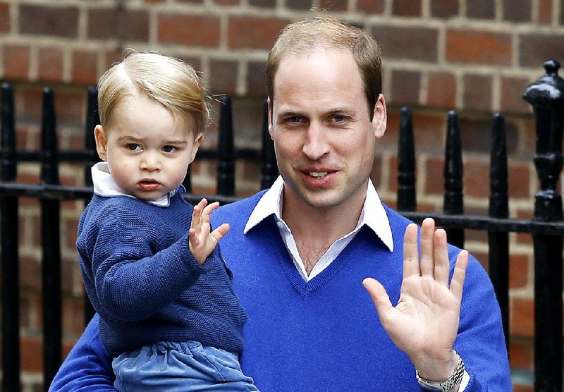 Britain's Prince William and his son Prince George wave in London in this May 2 file photo.