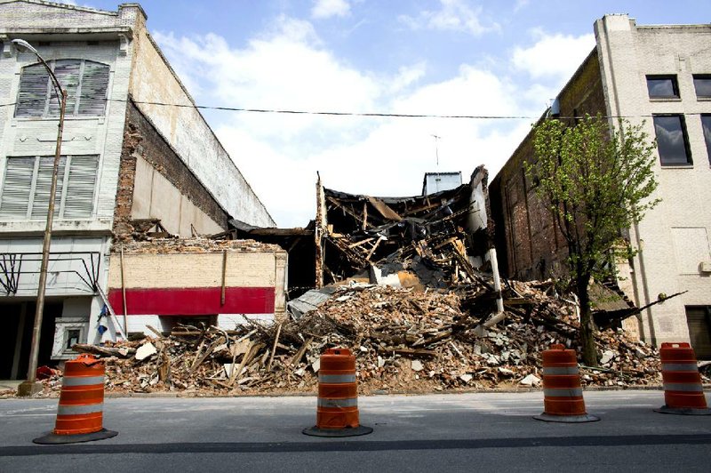 The former Kahn Jewelers building (left), the collapsed former Veterans of Foreign Wars post, and the collapsed former Band Museum sit abandoned on Main Street in Pine Bluff in this file photo from April 2.