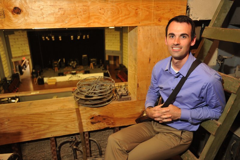 Garrett Brewer of Bentonville sits Wednesday in the old projection room in the back of the Meteor Guitar Gallery in Bentonville as he talks about plans for a new local radio station. A group of Bentonville residents are planning on creating a community radio station in the old projection room of the building that used to be a movie theater. For more photos, go to www.nwadg.com/photos.