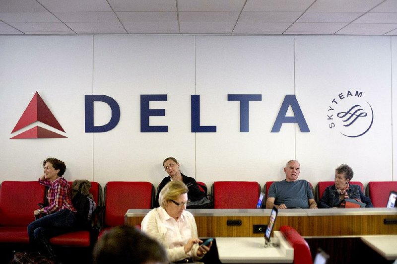 Travelers wait for a flight in the Delta Terminal D at LaGuardia Airport in New York in this file photo. Gov. Andrew Cuomo on Monday announced a $4 billion plan to rebuild the airport.