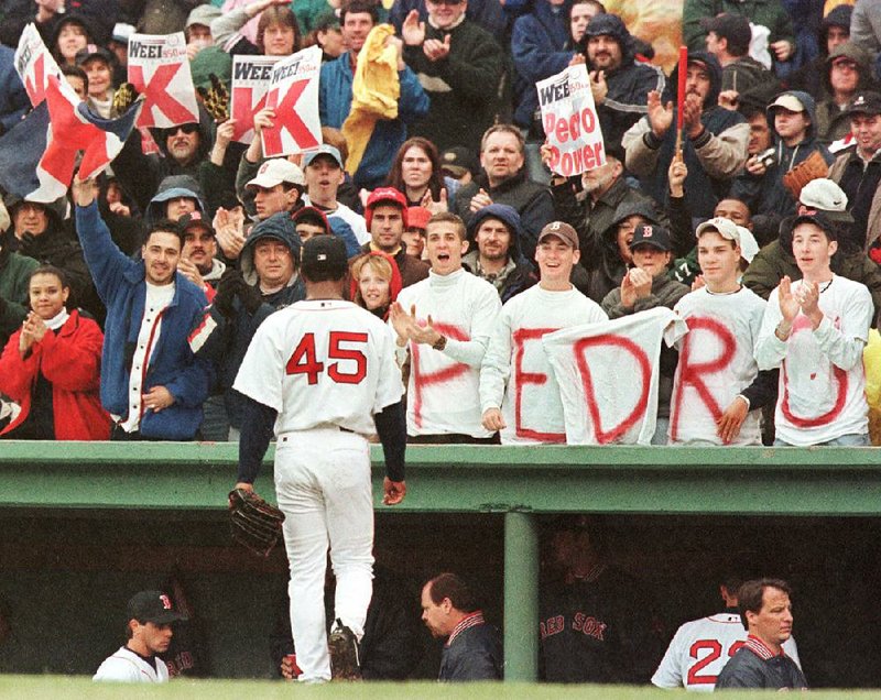 Boston Red Sox pitcher Pedro Martinez is cheered by fans as he walks back to the dugout after striking out the side against the Tampa Bay Devil Rays at Fenway Park in this April 2001 file photo.