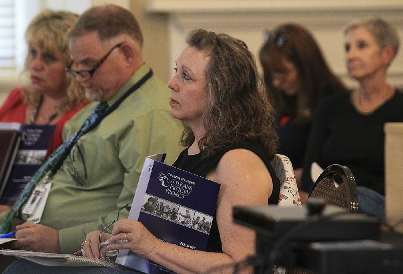Kay Tatum (center) and about 65 others gather at the MacArthur Museum of Arkansas Military History on Monday for a workshop tied to the Library of Congress’ Veterans History Project, which collects, preserves and makes accessible the personal accounts of America’s war veterans.