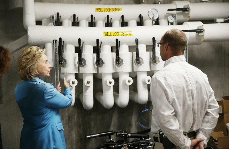 Democratic presidential candidate Hillary Rodham Clinton tours the Des Moines Area Rapid Transit Central Station on Monday in Des Moines, Iowa, with building superintendent Keith Welch.
