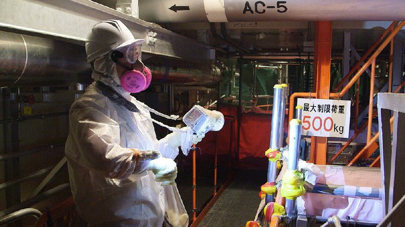 A worker checks the radiation levels at the crippled Fukushima Daiichi nuclear power plant in Japan.