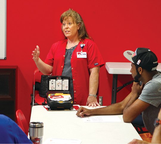 The Sentinel-Record/Richard Rasmussen AED DONATED: Cindy Draper, National Park Medical Center's director of education and cardiac rehabilitation, teaches a training session Monday for Hot Springs Family YMCA employees on the use of a new Automated External Defibrillator donated by NPMC and Hot Springs Cardiology Associates.