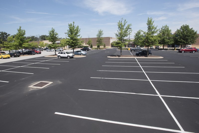 The parking lot at Steele Crossing is mostly empty Sunday. Fayetteville planning commissioners on Monday reviewed a proposal to remove the city’s minimum parking standards for all commercial properties. For more photos, go to www.nwadg.com/photos.