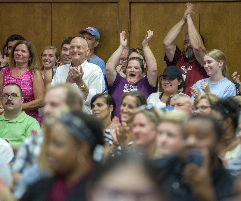 Some in attendance at Monday’s Fort Smith School Board meeting react after public input from Southside High School junior Christian Parker in support of keeping the school’s Rebel mascot and "Dixie" fight song.