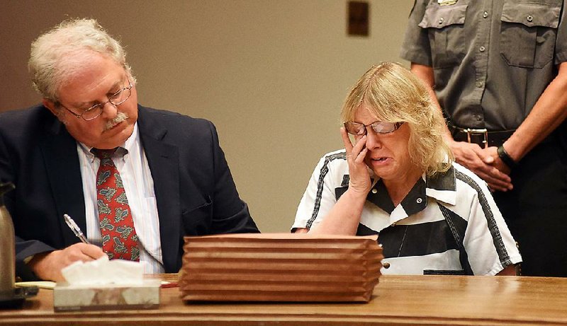 Joyce Mitchell cries as she sits with her attorney Stephen Johnston in court Tuesday in Plattsburgh, N.Y. Mitchell, an instructor in the tailor shop at the Clinton Correctional Facility, pleaded guilty to charges that she aided the escape of two convicted murderers. 