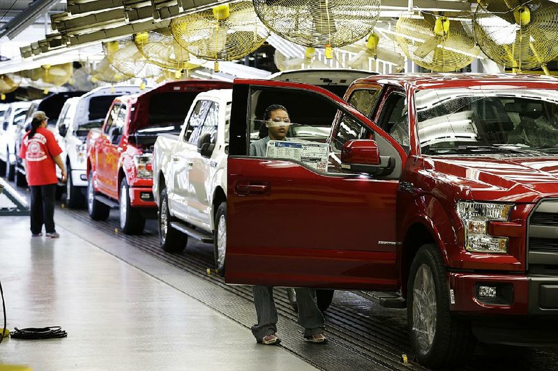 Assembly line workers inspect new aluminum-alloy body Ford F-150 pickups at Ford’s Kansas City Assembly Plant in Claycomo, Mo. 