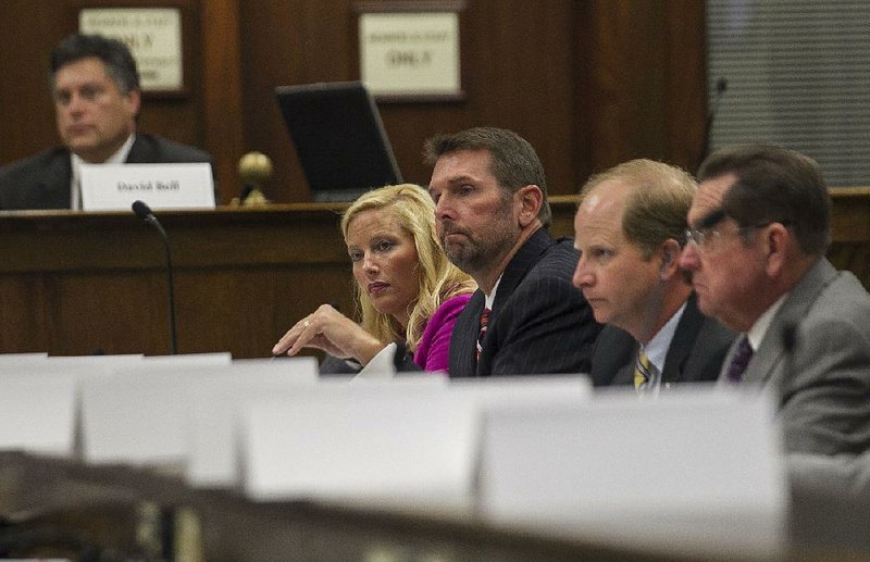 Shannon Newton (from left), president of the Arkansas Trucking Association; Scott Bennett, director of the Arkansas Highway and Transportation Department; and state Rep. Andy Davis, R-Little Rock, join the discussion during Tuesday’s meeting of the Governor’s Working Group on Highway Funding. 