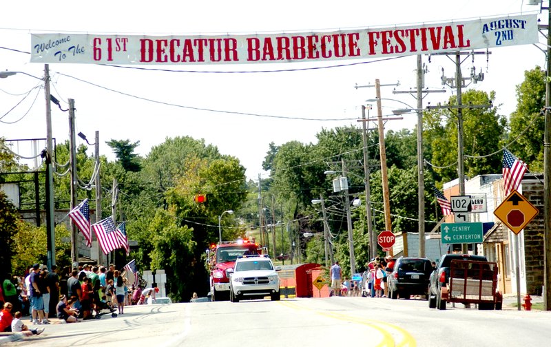 Photo by Mike Eckels The 61st Annual Decatur Barbecue parade makes it way down Main St. in Decatur August 3, 2014. The banner has held this same spot on Main St. for several years.