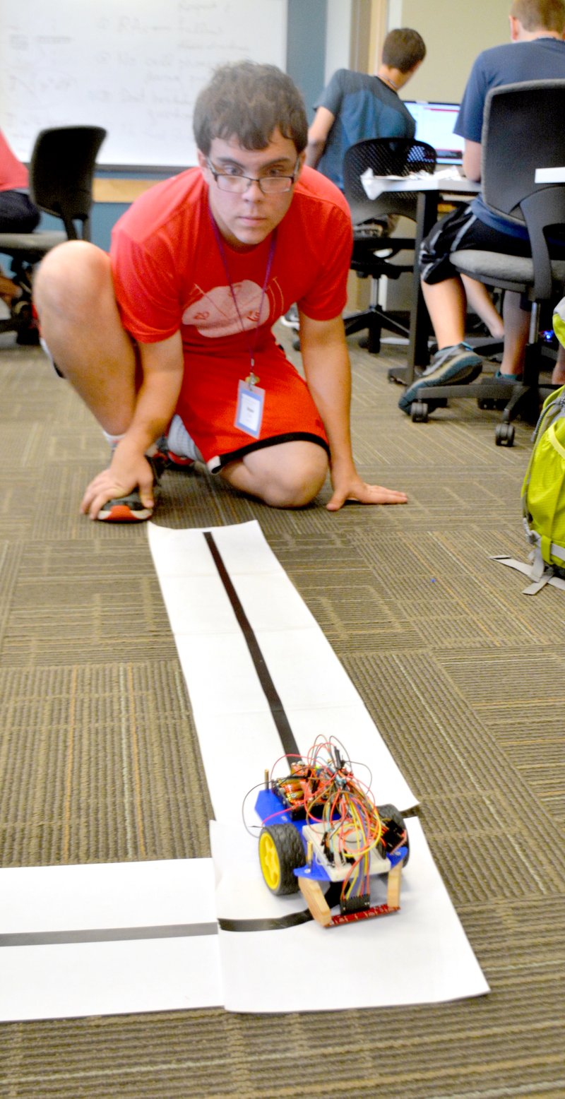 Janelle Jessen/Herald-Leader Bryson Cobb, a high school senior from Lewisville, Texas, did a test run with his robot on Wednesday afternoon.