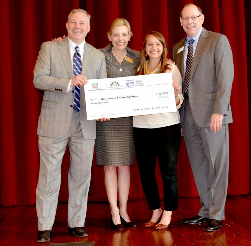 The Arkansas Historic Preservation Program, an agency of the Department of Arkansas Heritage, recently awarded Main Street Siloam Springs a $15,000 Main Street Downtown Revitalization Grant. From left: Lt. Gov. Tim Griffin, Department of Arkansas Heritage Director Stacy Hurst, Main Street Siloam Springs Director Meredith Bergstrom and Main Street Arkansas Director Greg Phillips.