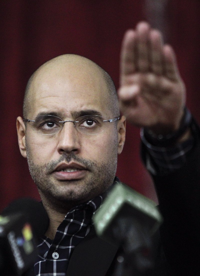 In this Thursday, March 10, 2011 file photo, Seif al-Islam Gadhafi, son of Libyan Leader Moammar Gadhafi, gestures as he speaks to supporters and the media in Tripoli. A Libyan court sentenced Seif al-Islam, to death over killings in 2011 uprising on Tuesday, July 28, 2015.