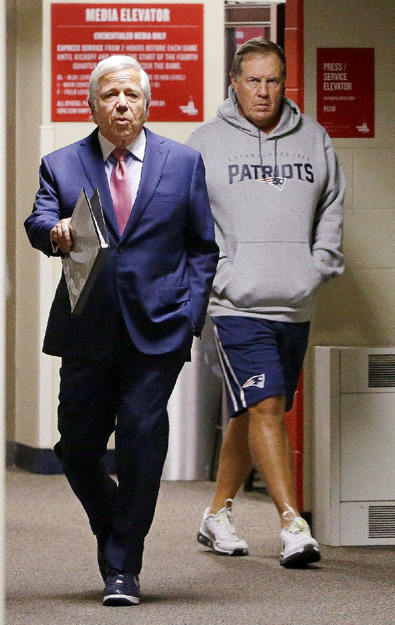 New England Patriots owner Robert Kraft, left, and head coach Bill Belichick enter a room full of reporters to address NFL Commissioner Roger Goodell's action upholding New England Patriots quarterback Tom Brady's four game "Deflategate"suspension during an NFL football training camp media availability at the team's facility Wednesday, July 29, 2015, in Foxborough, Mass. 