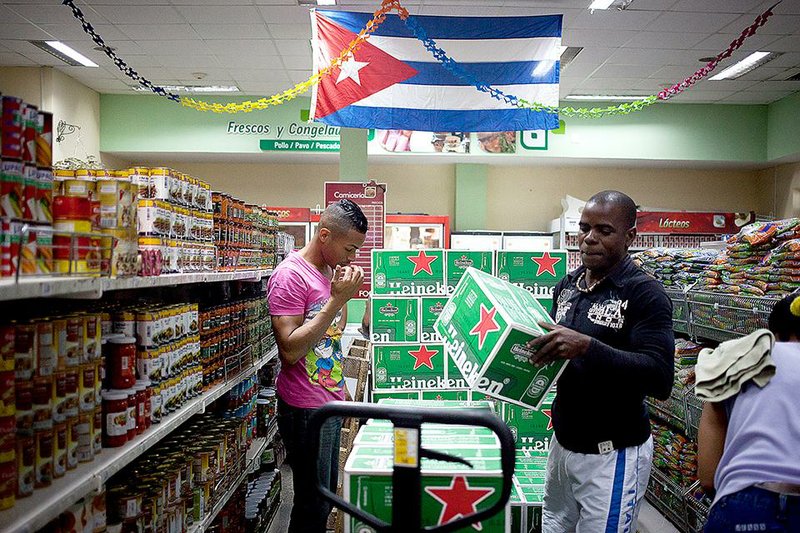 A worker unloads Heineken beer at a store in Havana in this file photo. The ongoing trade embargo and new rules are slowing the movements of U.S. businesses that hope to expand in Cuba.