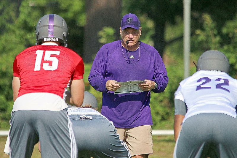 UCA football Coach Steve Campbell (center).