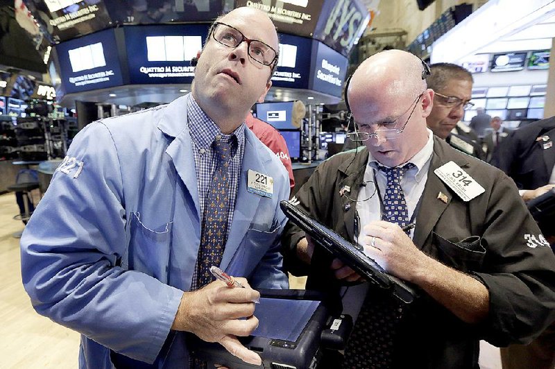 Traders Peter Mancuso (left) and Kevin Walsh work Wednesday on the floor of the New York Stock Exchange.