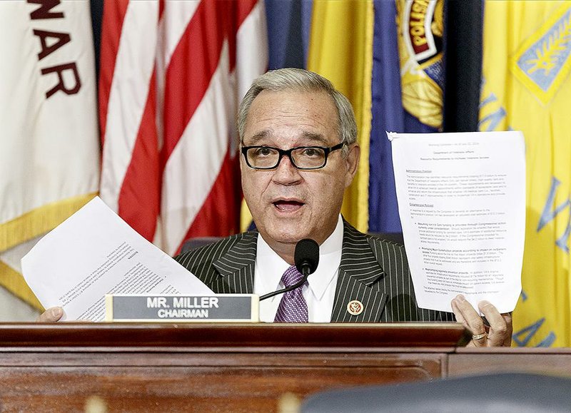 In this July 24, 2014 file photo, House Veterans Affairs Committee Chairman Jeff Miller, R-Fla., holds up two pages of resource requests from the Department of Veterans Affairs during a hearing on Capitol Hill in Washington. 