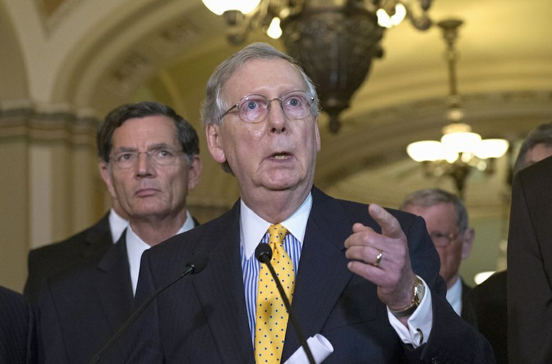 In this July 21, 2015, file photo, Senate Majority Leader Mitch McConnell, R-Ky., speaks during a news conference on Capitol Hill in Washington. The Senate passed a long-term transportation bill Thursday, but with House lawmakers already dispersed for their August recess the bill becomes just one more sticky issue on a jam-packed congressional agenda in the fall. Sen. John Barrasso, R-Wyo. is at left. 