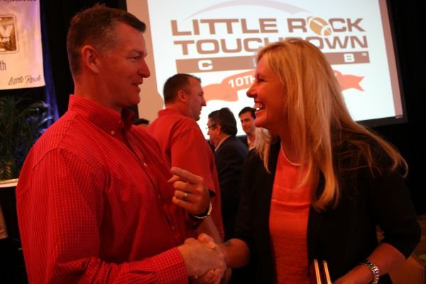 Arkansas Razorback Foundation director Sean Rochelle of Fayetteville and Judy Henry of Little Rock at the first Touchdown Club luncheon of the 2013 program featuring UA Coach Bret Bielema at the Marriott.