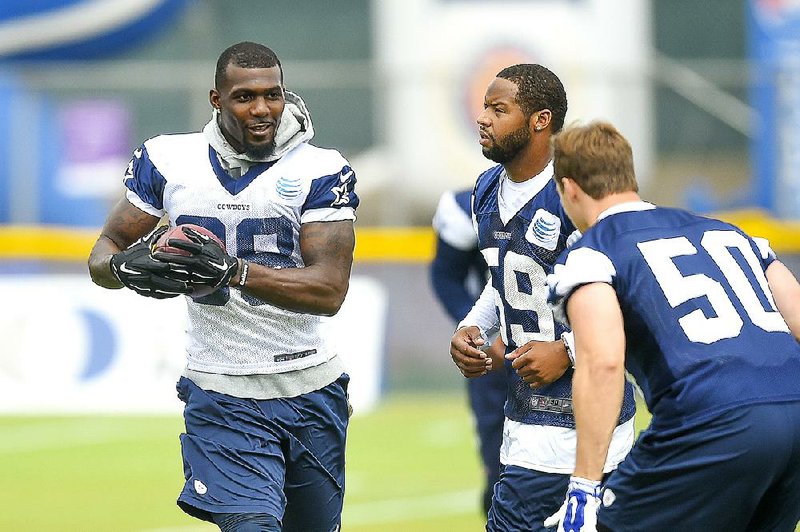 Dallas wide receiver Dez Bryant (left) runs by outside linebacker Anthony Hitchens (59) and middle linebacker Sean Lee on Thursday during the Dallas Cowboys' NFL training camp in Oxnard, Calif.