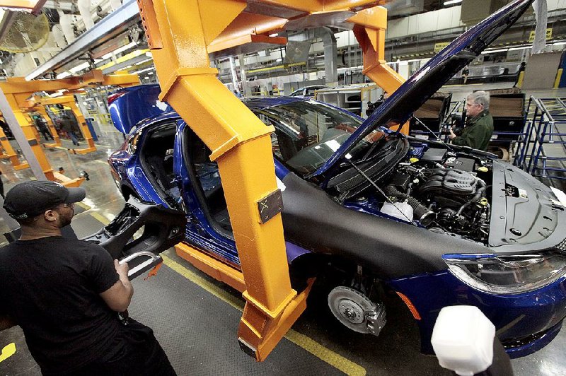 A worker on the line at the Sterling Heights Assembly Plant in Sterling Heights, Mich., prepares a 2015 Chrysler 200 earlier this year. Fiat Chrysler Automobiles reported a net profit for the quarter ending June 30 of $364 million, compared with $215 million a year ago. 