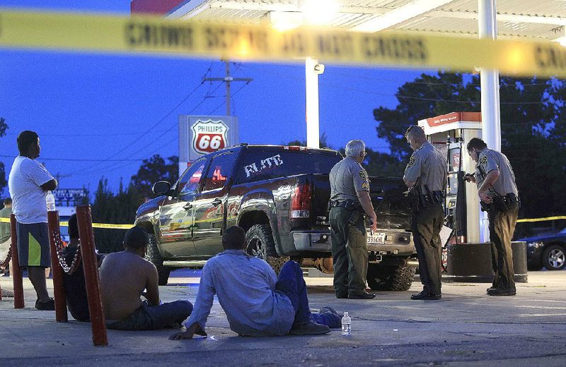 Pulaski County sheriff’s deputies investigate a report of shots fired Thursday night at a gas station on MacArthur Drive near Interstate 40 in Morgan. No one was hurt.