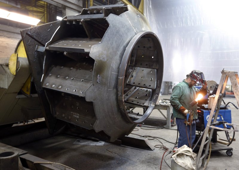 In this photo taken on Thursday, Feb. 12, 2015, a man welds parts in fans for industrial ventilation systems at the Robinson Fans Inc. plant in Harmony, Pa. The Commerce Department releases second-quarter gross domestic product on Thursday, July 30, 2015.