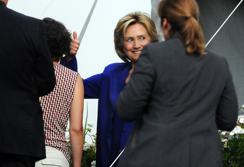 Presidential candidate  Hillary Rodham Clinton gestures with a smile after speaking during a private fundraiser at the home of long time supporter Virginia McGregor in the Green Ridge section of Scranton, Pa., on Wednesday, July 29, 2015. 