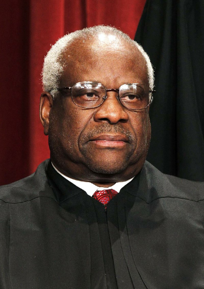 Associate Justice Clarence Thomas poses in this August 2010 file photo.