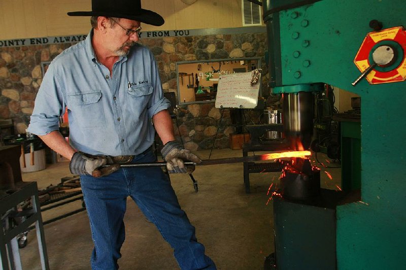 Jerry Fisk (in 2012) uses a machine to hammer the heated steel he is folding for a Damascus steel blade at his shop near Nashville. Fisk is one of this year’s inductees into the state Game and Fish Commission’s Outdoor Hall of Fame.