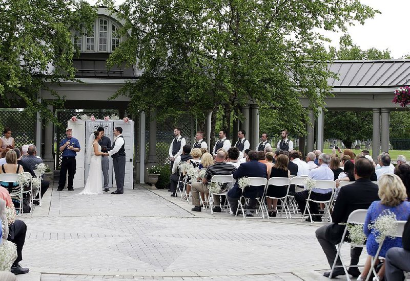 Danessa Molinder and Billy Castrodale get married in the courtyard of the Community Life Center in Indianapolis in June. The center sits on cemetery land near a funeral home. 