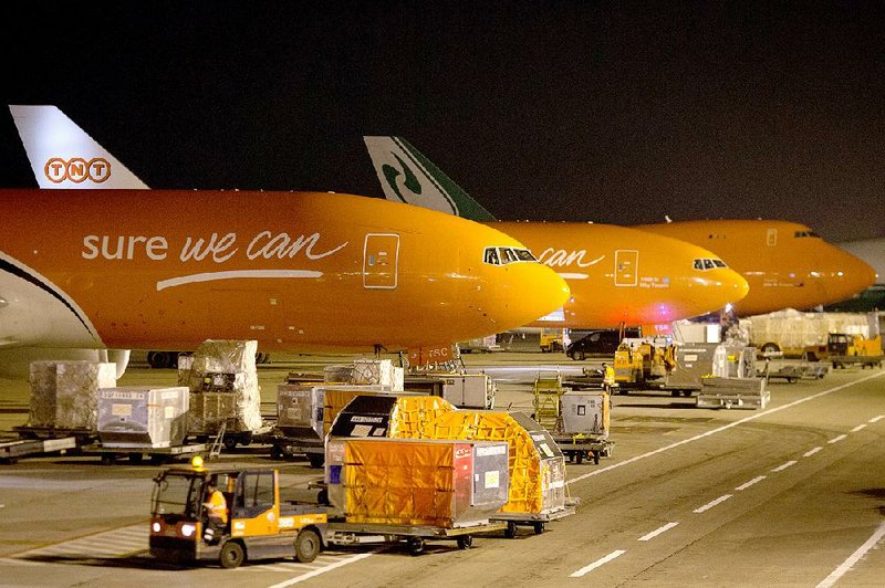 Cargo jets stand on the apron at TNT Express NV’s European mail hub at Leige Airport in Grace-Hollogne, Belgium, last month. European Union regulators fear higher delivery prices from a tie-up of FedEx and TNT Express.