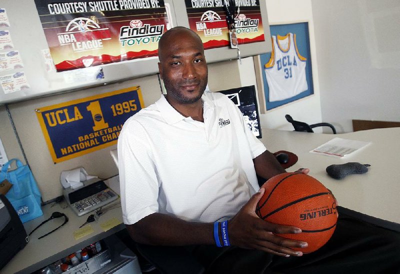 In this Sept. 18, 2010, file photo, former UCLA basketball player Ed O'Bannon Jr. sits in his office in Henderson, Nev. 