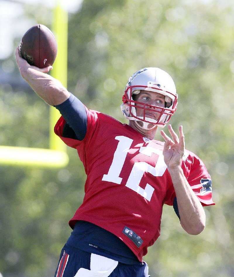 New England Patriots quarterback Tom Brady throws during a training camp session Friday in Foxborough, Mass. Brady, who is appealing a four-game suspension for his role in the team’s use of deflated footballs last season, and NFL Commissioner Roger Goodell might be appearing in federal court later this month. 