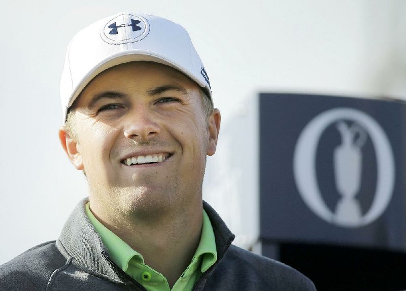 Jordan Spieth smiles as play resumes on the 16th hole during the second round of the British Open Golf Championship at the Old Course, St. Andrews, Scotland, Saturday, July 18, 2015. 