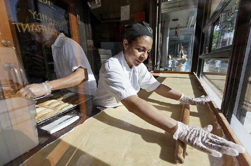 A baker works at Ted’s Bulletin, a Capitol Hill restaurant, in May. The Labor Department’s measurement of wages and benefits, the employment cost index, rose 0.2 percent in the April-June quarter. 