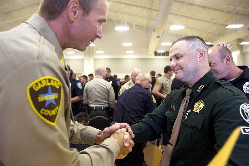 Garland County Chief Deputy Jason Lawrence (left) congratulates new officer Daniel Brewer after graduation Friday at the Arkansas Law Enforcement Training Academy at Southern Arkansas University-Tech in East Camden.