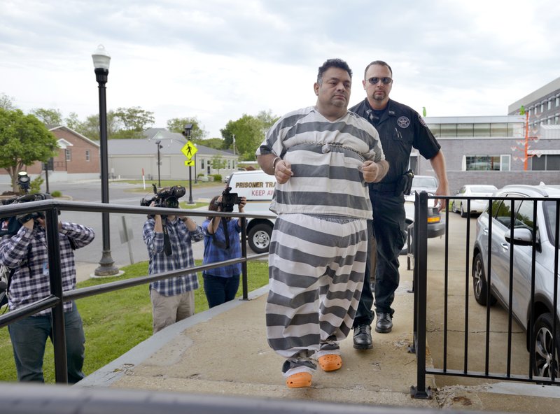 Benton County Sheriff’s Deputies escort Mauricio Torres into the Benton County Courthouse Annex in Bentonville for an arraignment hearing May 4 before Circuit Judge Brad Karren. Terri Chambers, one of his attorneys, told Karren on Friday she may file a motion to reschedule the trial.