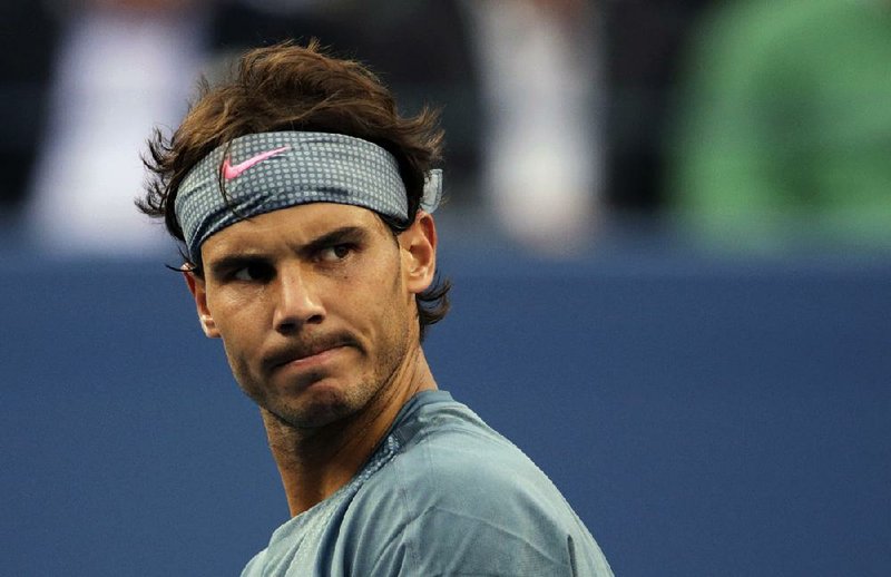 Rafael Nadal reacts after a point against Novak Djokovic in this September 2013 file photo.