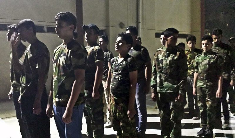 Young volunteers train at a Popular Mobilization Forces center in Baghdad in mid-July. 