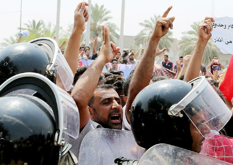 Demonstrators march Saturday in the southern Iraqi city of Basra to protest daily cuts in electricity. As temperatures rise above 120 degrees, demonstrators across Iraq are demanding better service. Prime Minister Haider al-Abadi declared a four-day weekend to help people cope with the heat and ordered an end to round-the-clock power for government officials. 