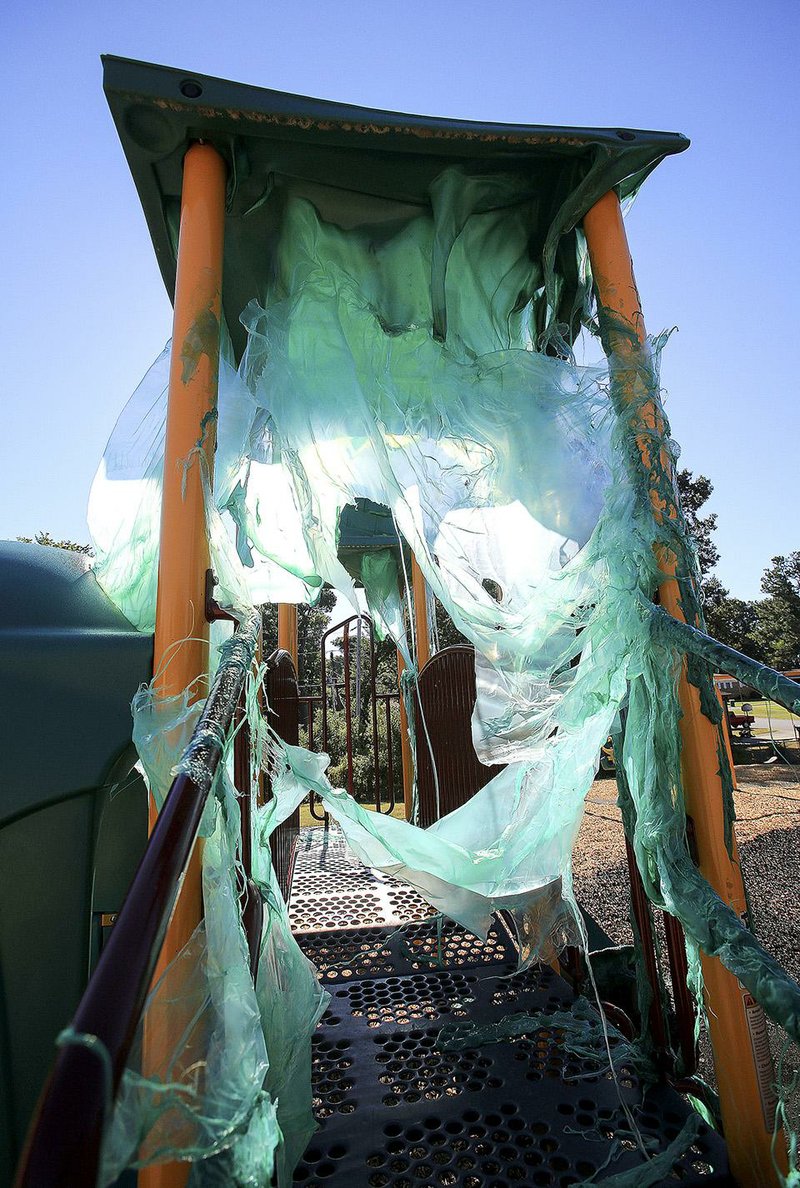 Melted plastic covers playground equipment Aug. 1, 2015, at the Franklin Elementary School playground in Little Rock after a fire July 31. Capt. Randy Hickmon of the Little Rock Fire Department said investigators plan to look at video footage from cameras near the school in an effort to determine what caused the fire.