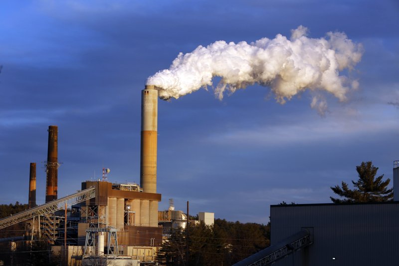 In this Jan. 20, 2015 file photo, a plume of steam billows from the coal-fired Merrimack Station in Bow, N.H. President Barack Obama on Monday, Aug. 3, 2015, will unveil the final version of his unprecedented regulations clamping down on carbon dioxide emissions from existing U.S. power plants. The Obama administration first proposed the rule last year. Opponents plan to sue immediately to stop the rule's implementation. 