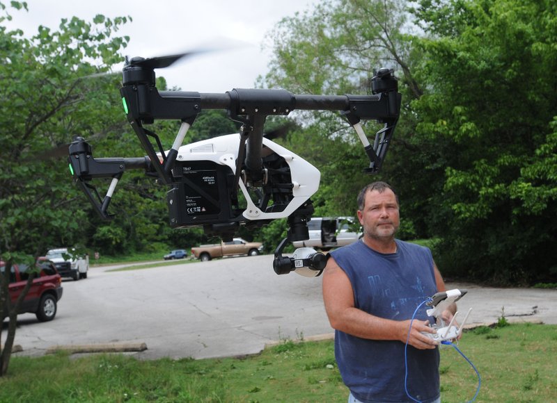 Jimmy Harmon of Bella Vista flies his drone June 19 near Lake Bella Vista. Harmon said he uses the aircraft in his photography business, Phonamic.