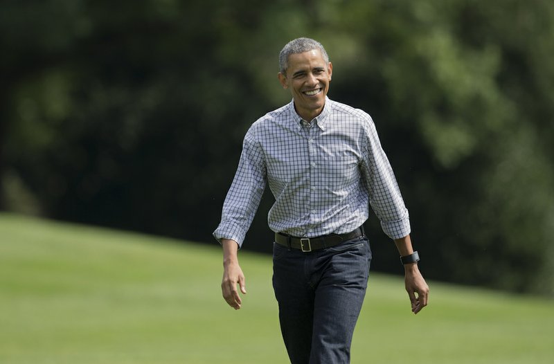 President Barack Obama, walks on the South Lawn as he arrives the White House in Washington, Sunday, Aug. 2, 2015, from Camp David, Md.