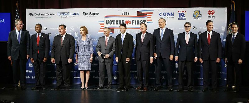 Republican presidential candidates gather on stage before a forum Monday in Manchester, N.H. From left: Jeb Bush, Ben Carson, Chris Christie, Carly Fiorina, Lindsey Graham, Bobby Jindal, John Kasich, George Pataki, Rick Perry, Rick Santorum, and Scott Walker.